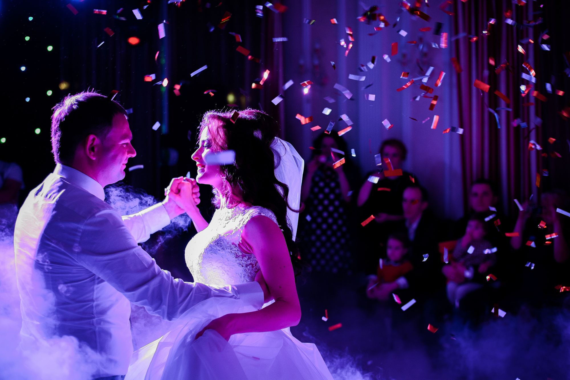 Confetti Fall On Wedding Couple Whirling In The Smoke