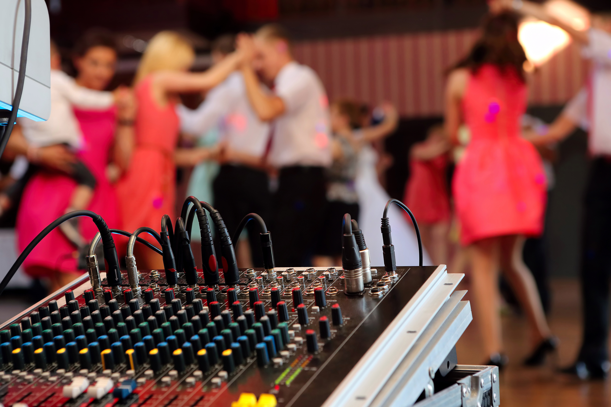 DJ Mixer With People Dancing On The Background